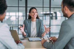 Woman excitedly discussing new project with colleagues