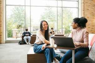 Two university students working together in modern student center