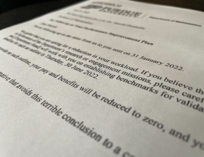 A letter lying flat with the prominent text "your pay and benefits will be reduced to zero"